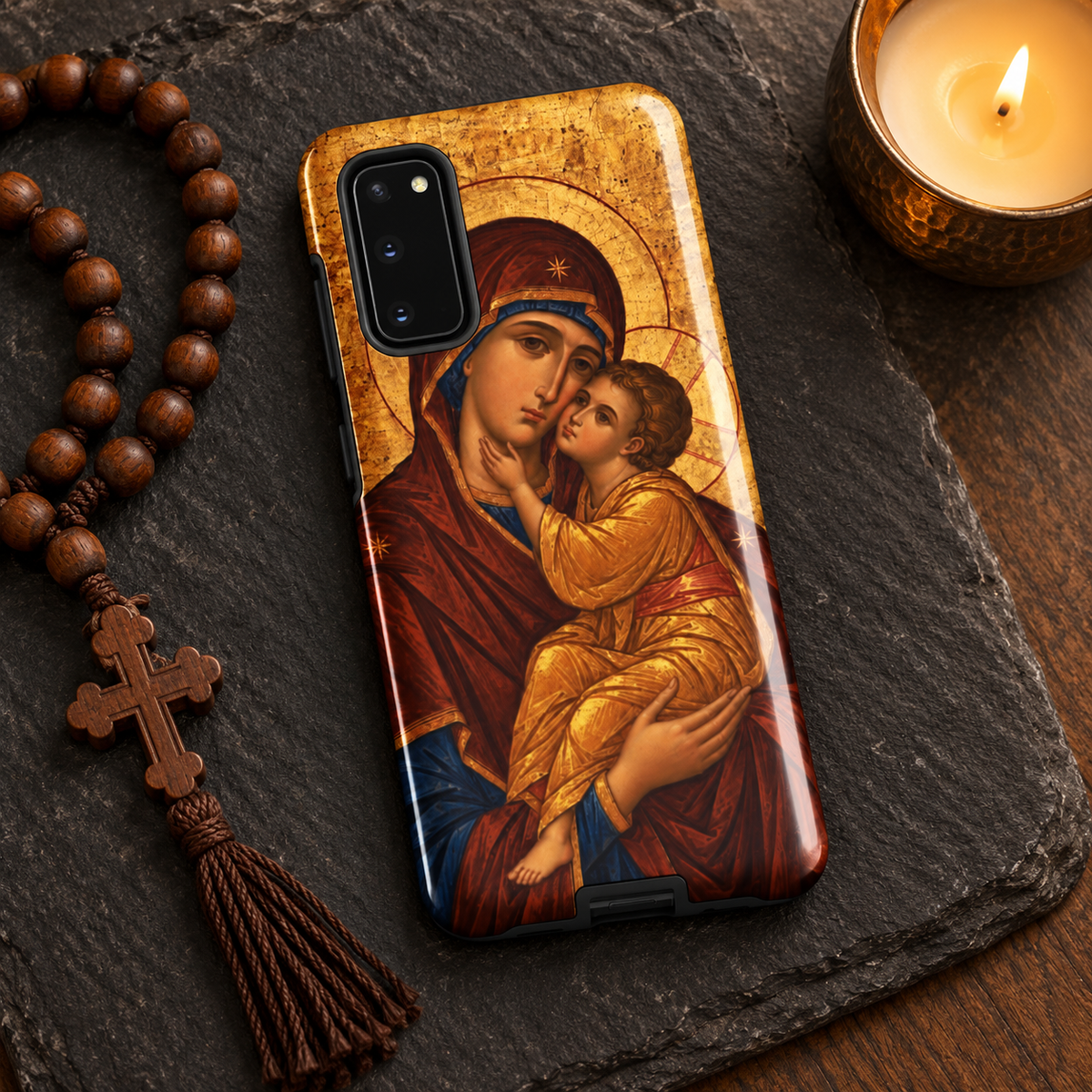 Theotokos icon Samsung Galaxy case on dark slate with a wooden prayer rope and candle