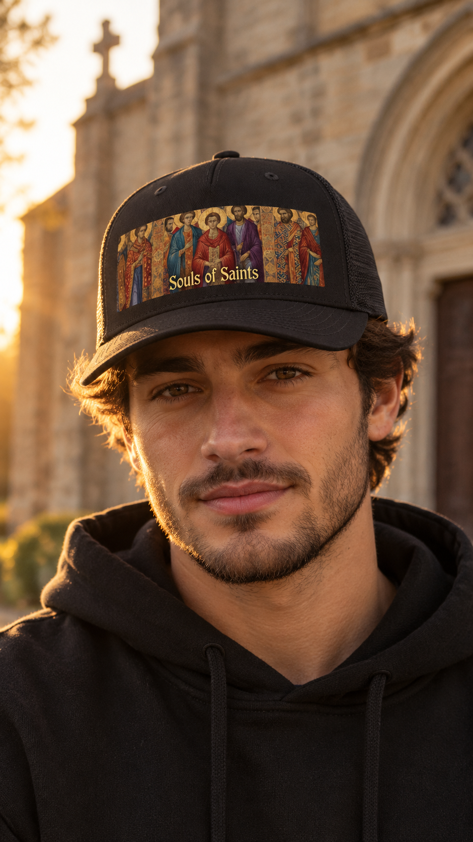 Man wearing the Souls of Saints Byzantine saints trucker cap outside a stone church